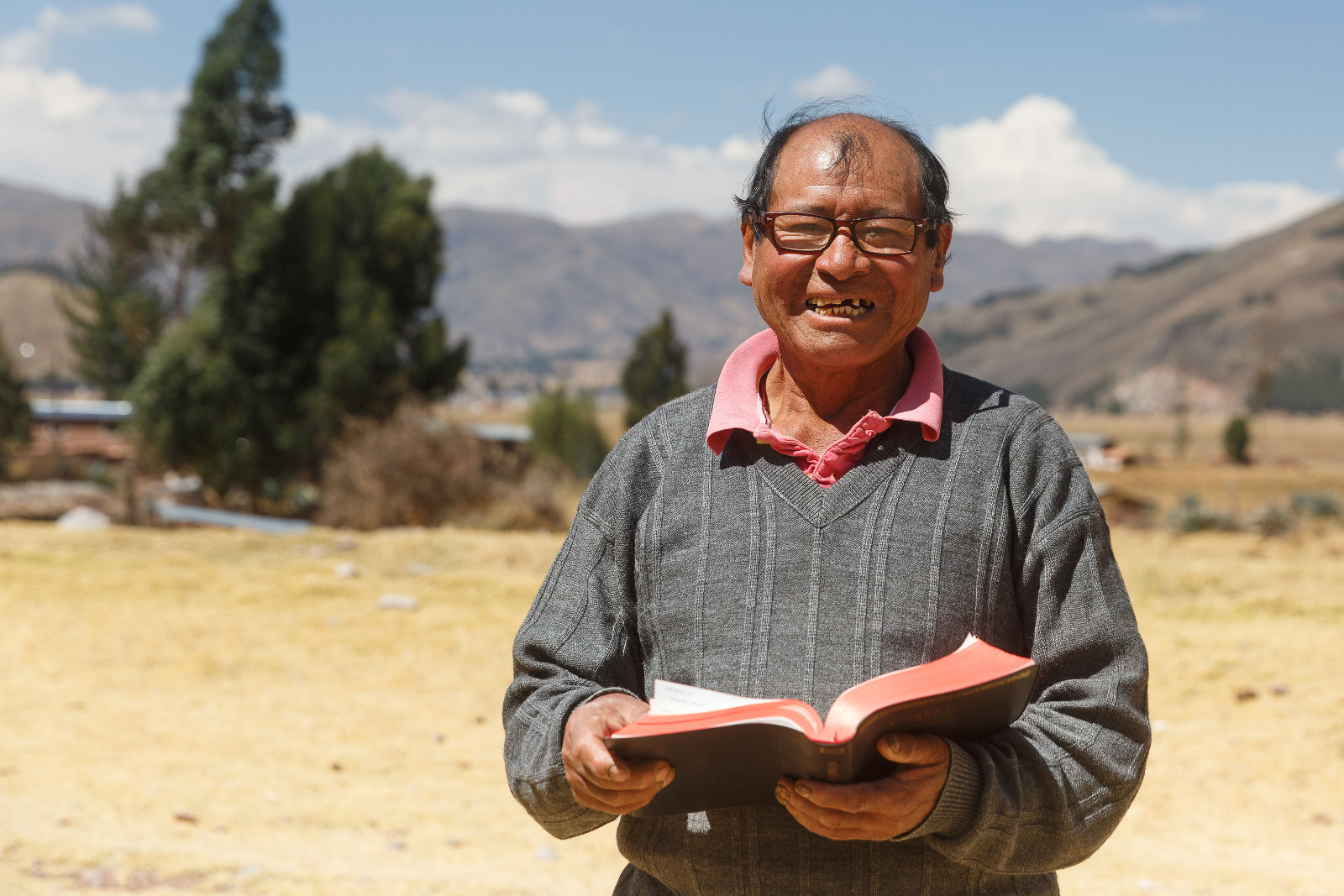 man holding open Bible